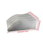 Close-up of a hand pressing on a partially inflated leg elevation pillow, demonstrating adjustable firmness