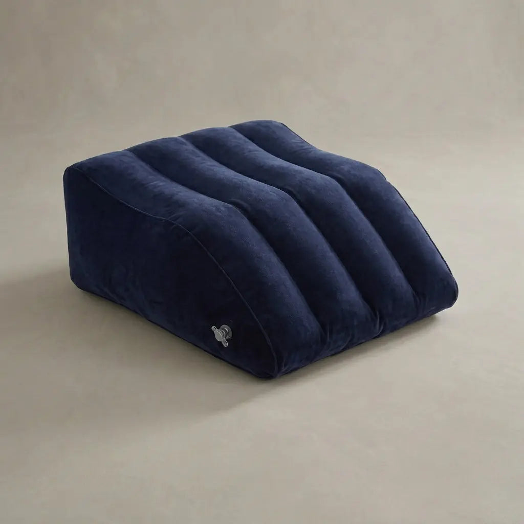 Hand compressing the surface of an inflatable wedge pillow to show how it can provide soft, gentle support